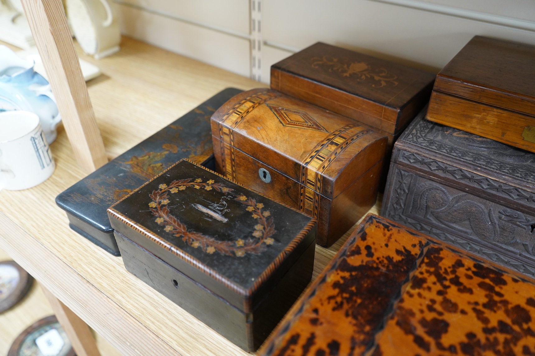 A blonde tortoiseshell veneered box, six other boxes and a miniature bagatelle board
